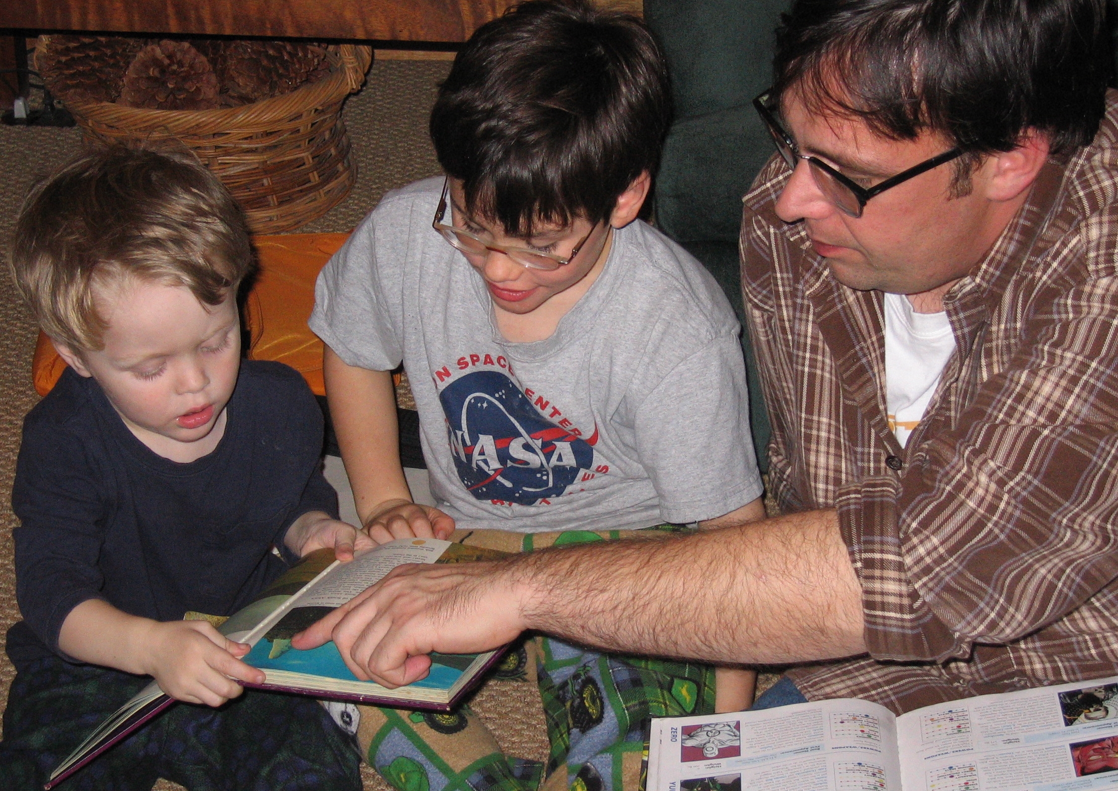 Father teaching his children to read