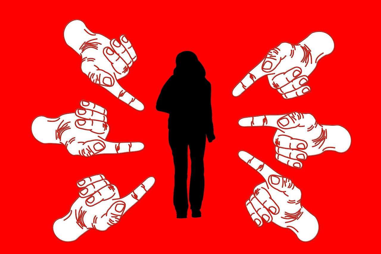 Bullying: Fingers pointing towards a girl